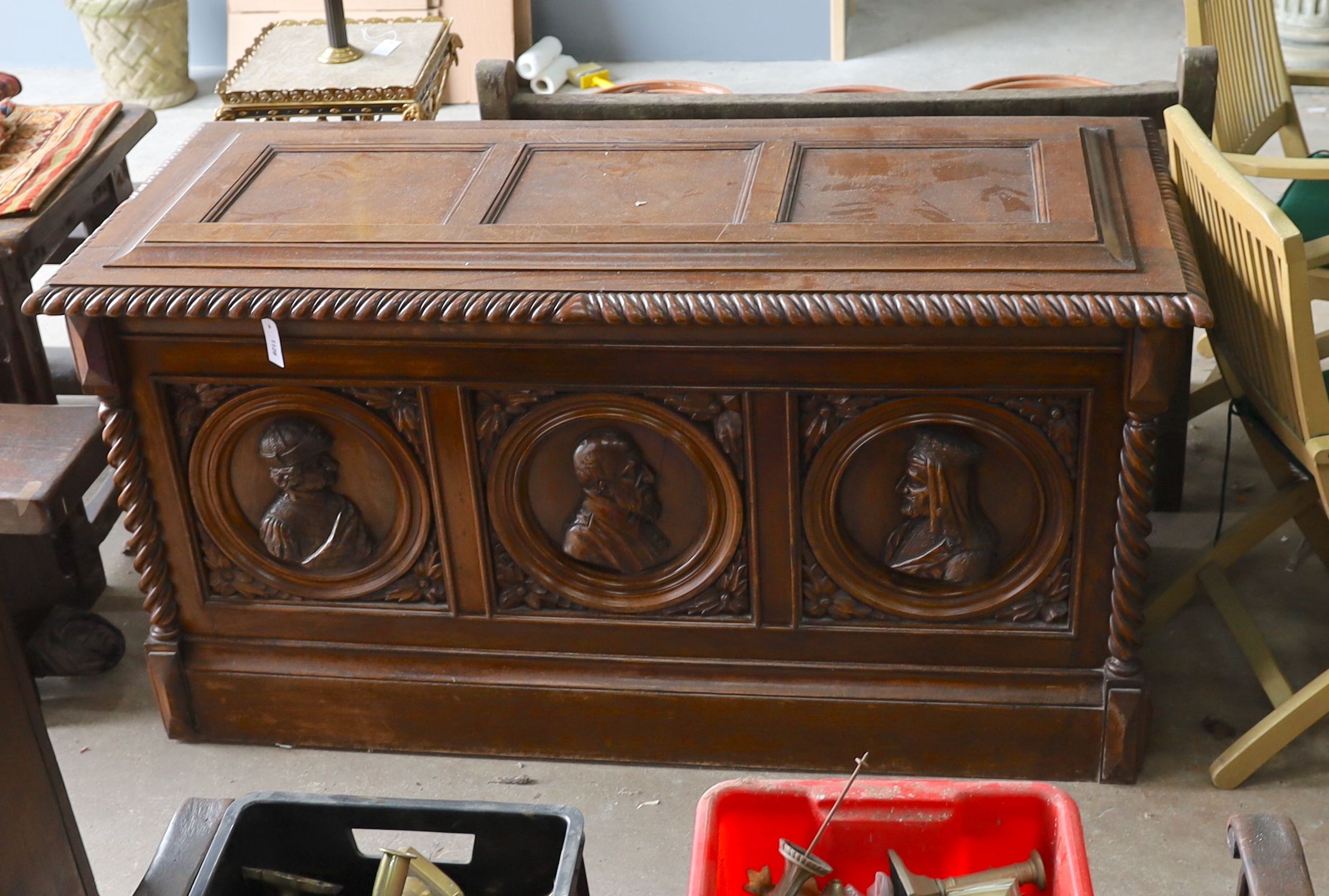 A 17th century style walnut cassone carved with busts in relief, width 160cm, depth 70cm, height 84cm
